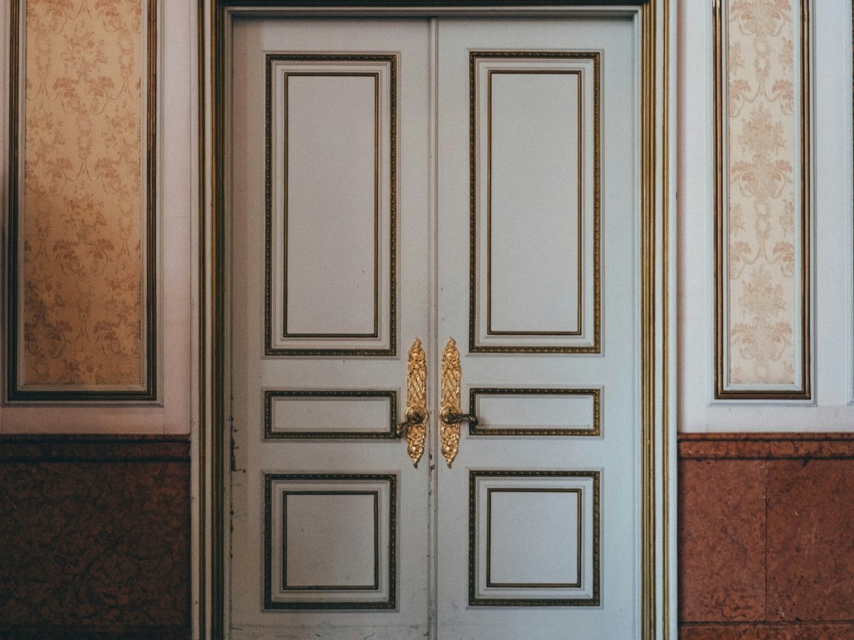 French chateau double door with Grand Cadre moldings and brass hardware
